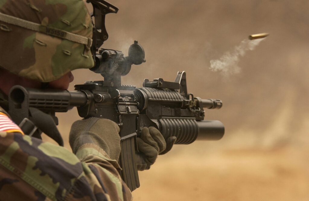 A soldier is shooting with his gun.